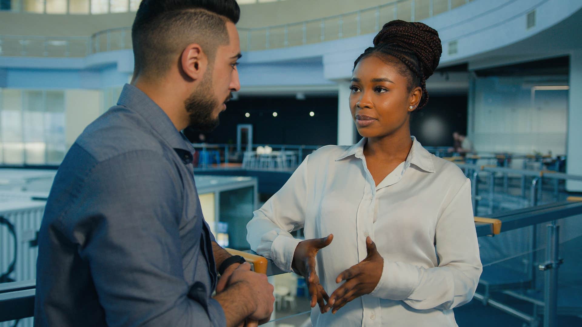 man in blue attracting mentor as woman explains to him