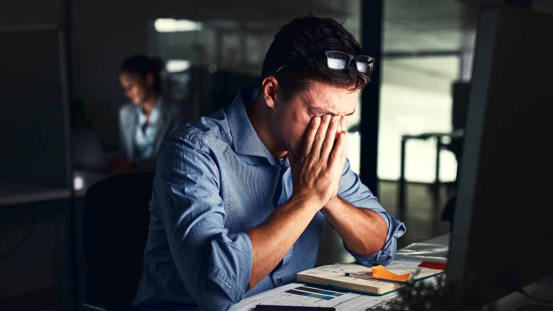 man in blue shirt starts hating his old job as he looks visibly stressed