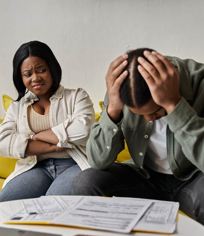 Defensive woman looks at stressed man