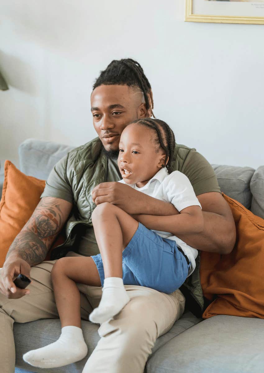 dad holding his son close on his lap