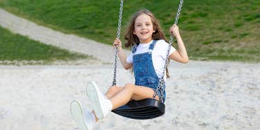 Experts Say Swinging Is Beneficial For All Ages young girl on swing