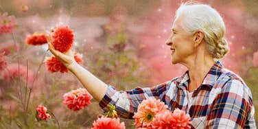 Happy woman picking flowers 