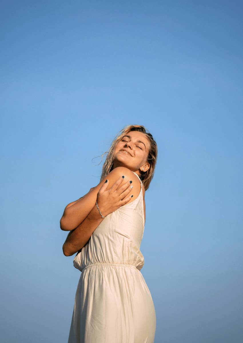 happy woman giving herself a hug