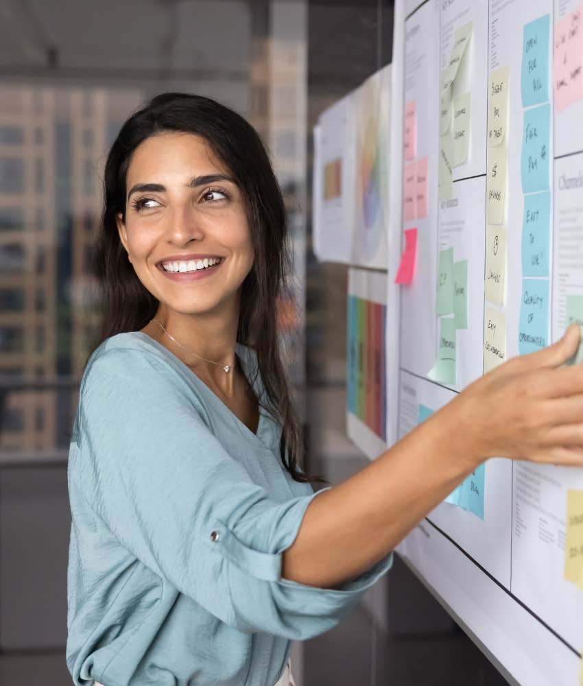 Happy person adds note to schedule showing respectful way to stop putting everything off