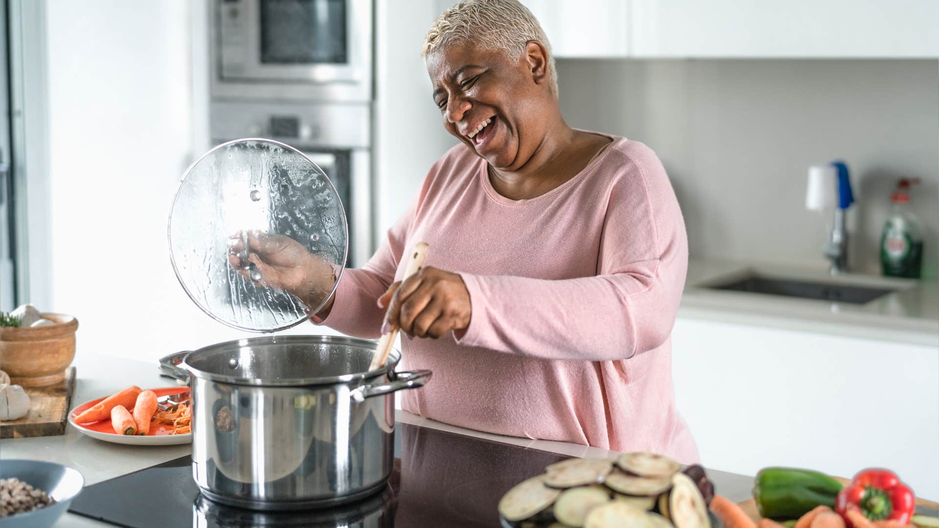 older woman using used appliances to cook