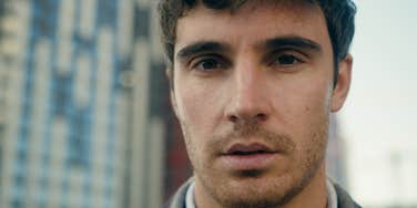 sad serious man staring ahead