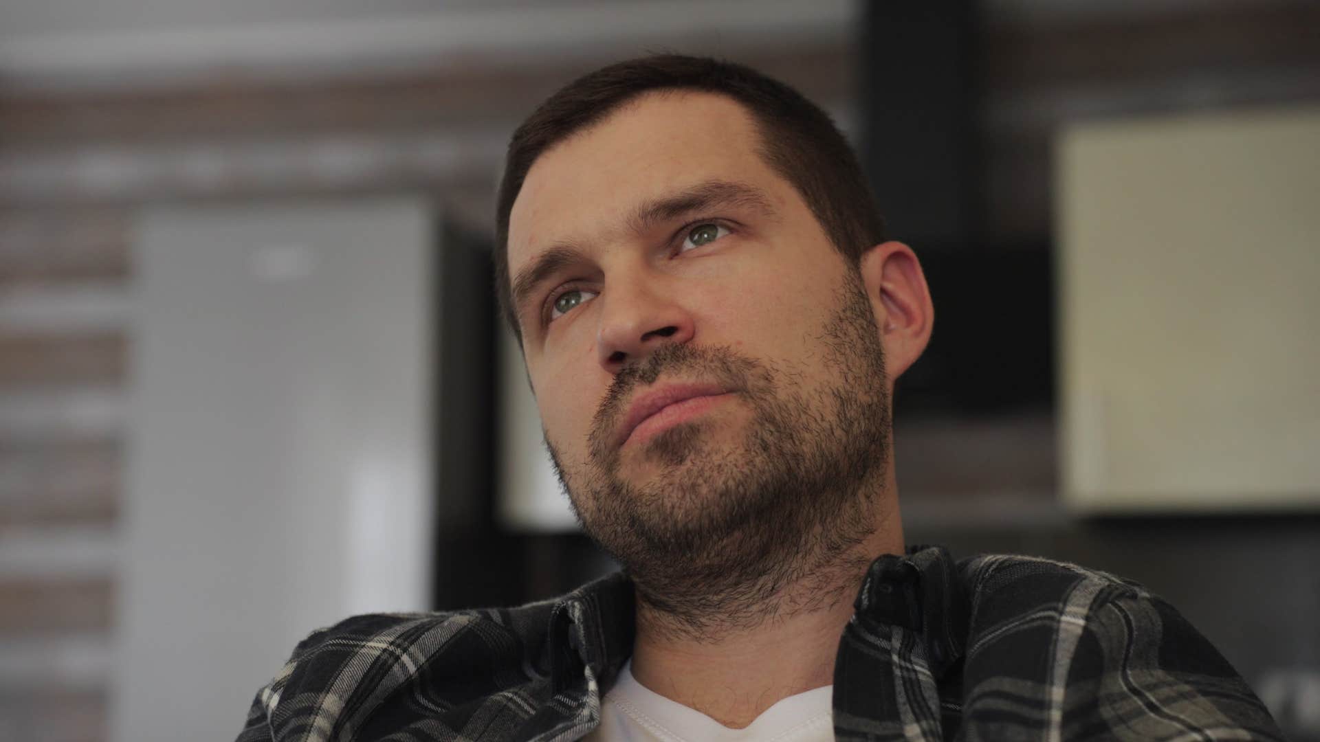 thoughtful man sitting on couch blaming others