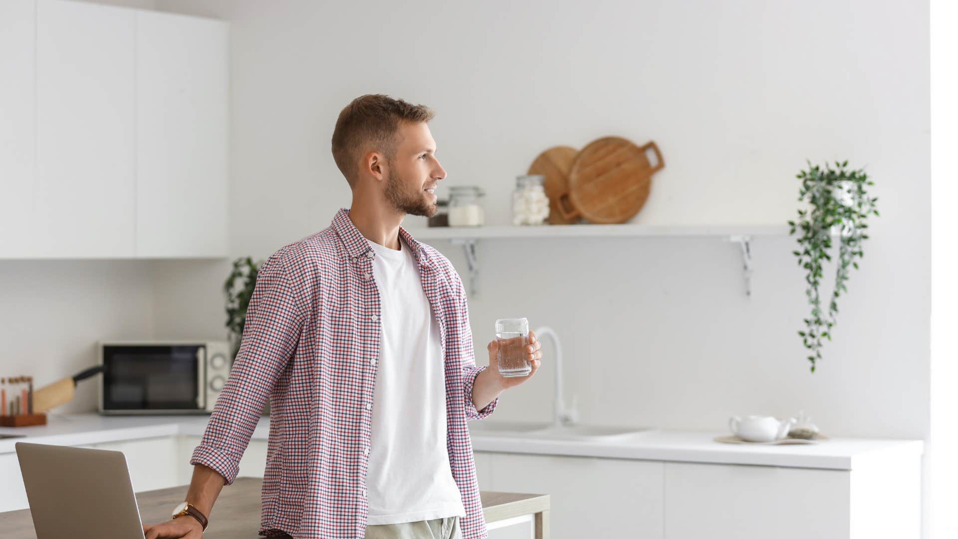 lazy man standing in kitchen not prepping meals