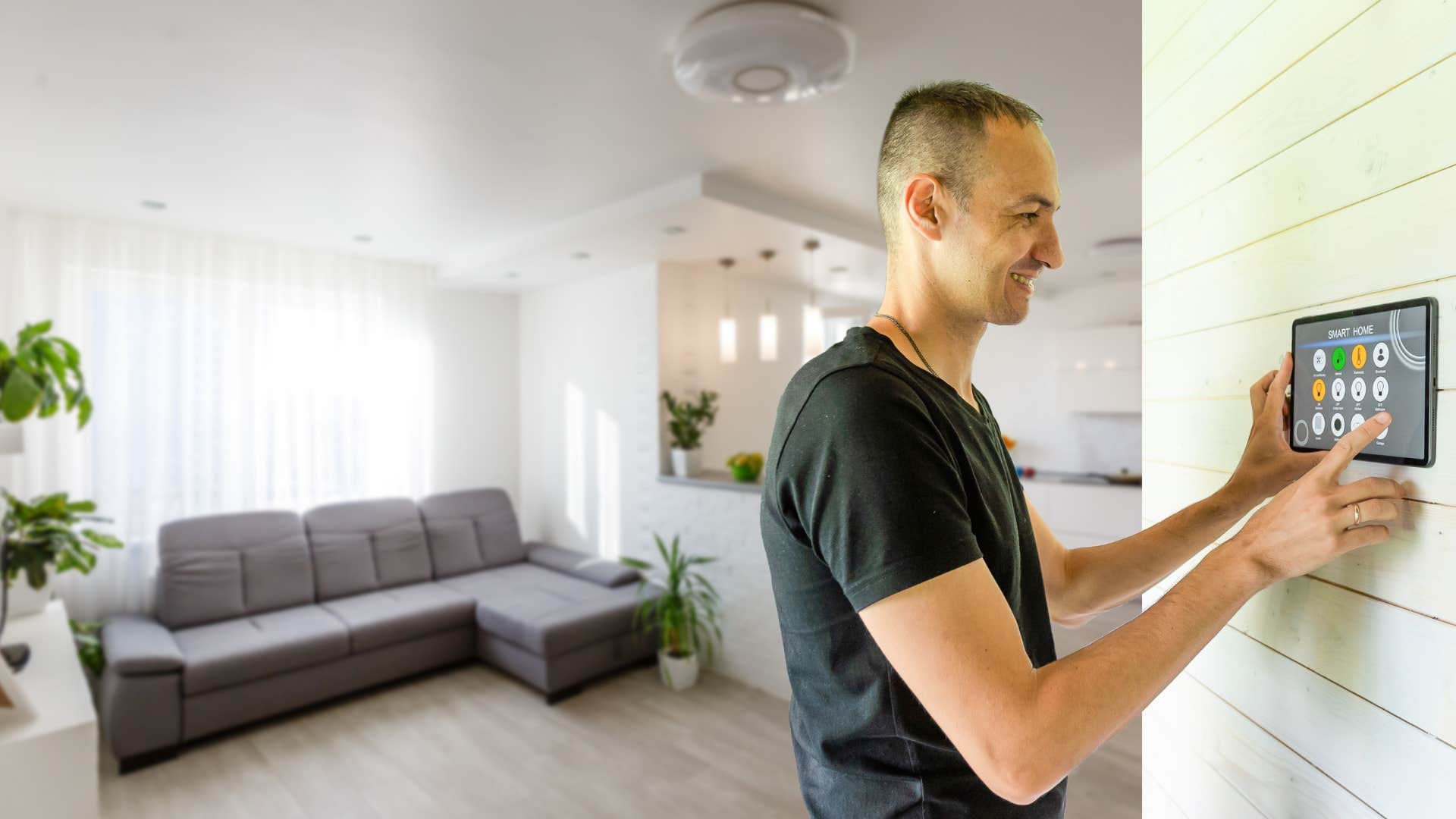 man turning on lights in room at home