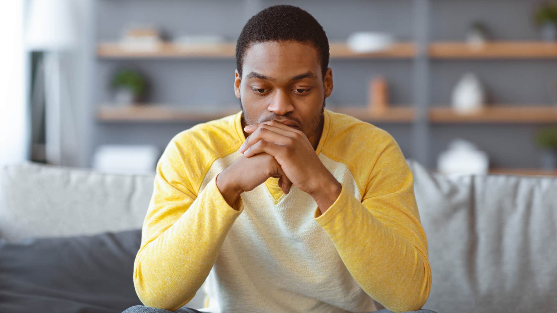 upset man sitting on couch showing no empathy