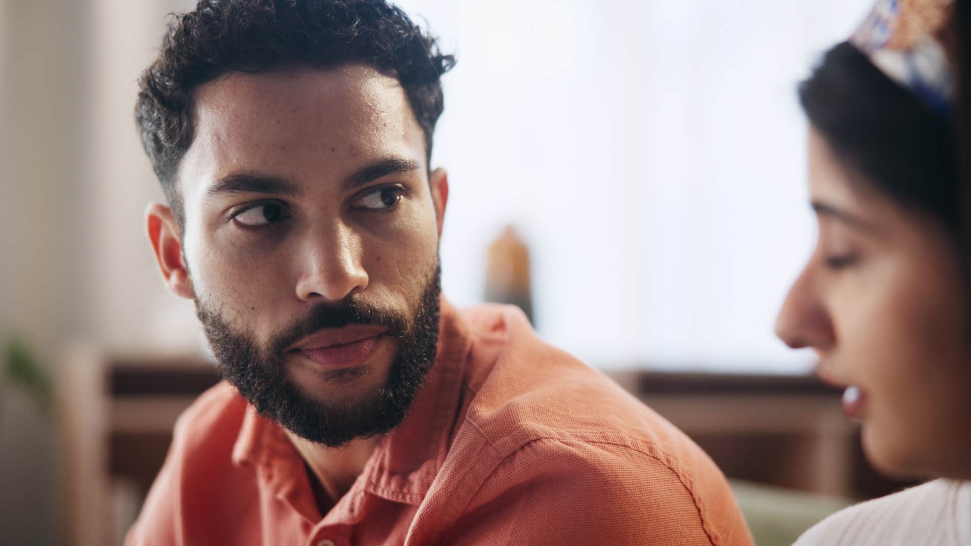 man listening to woman talk about him using her things without asking