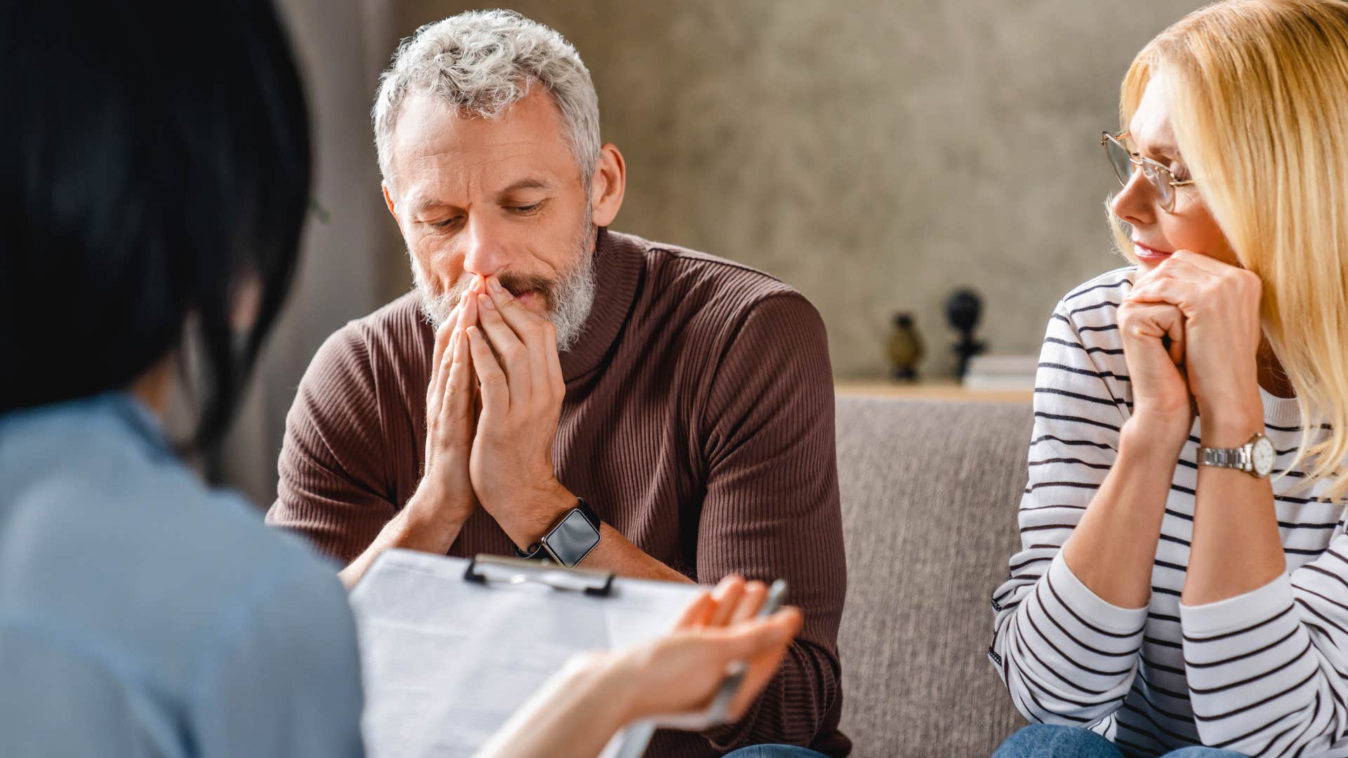 Man who can question everything sitting in therapy with his wife.