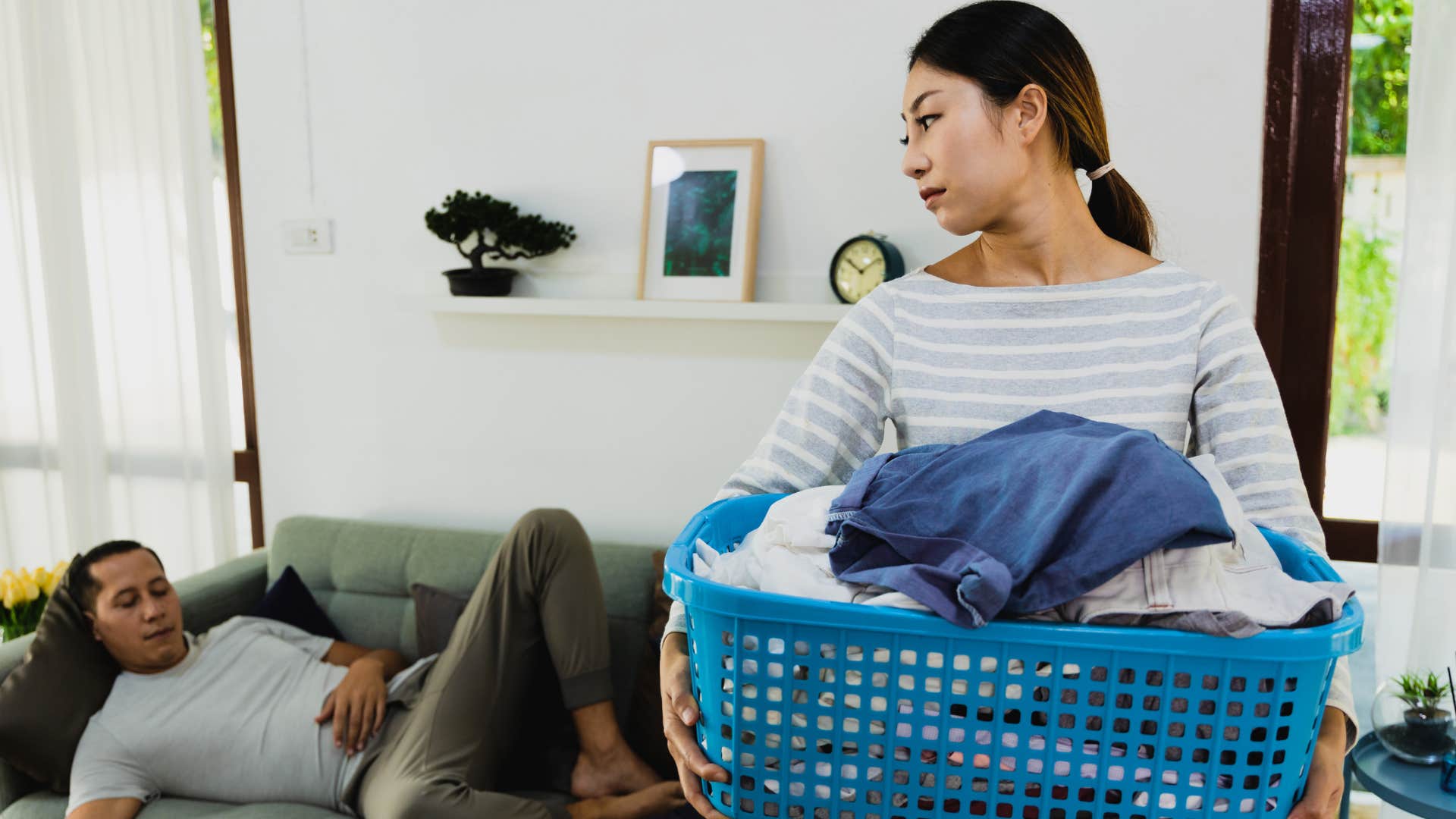 Woman looking at her husband who's stopped helping with household responsibilities.