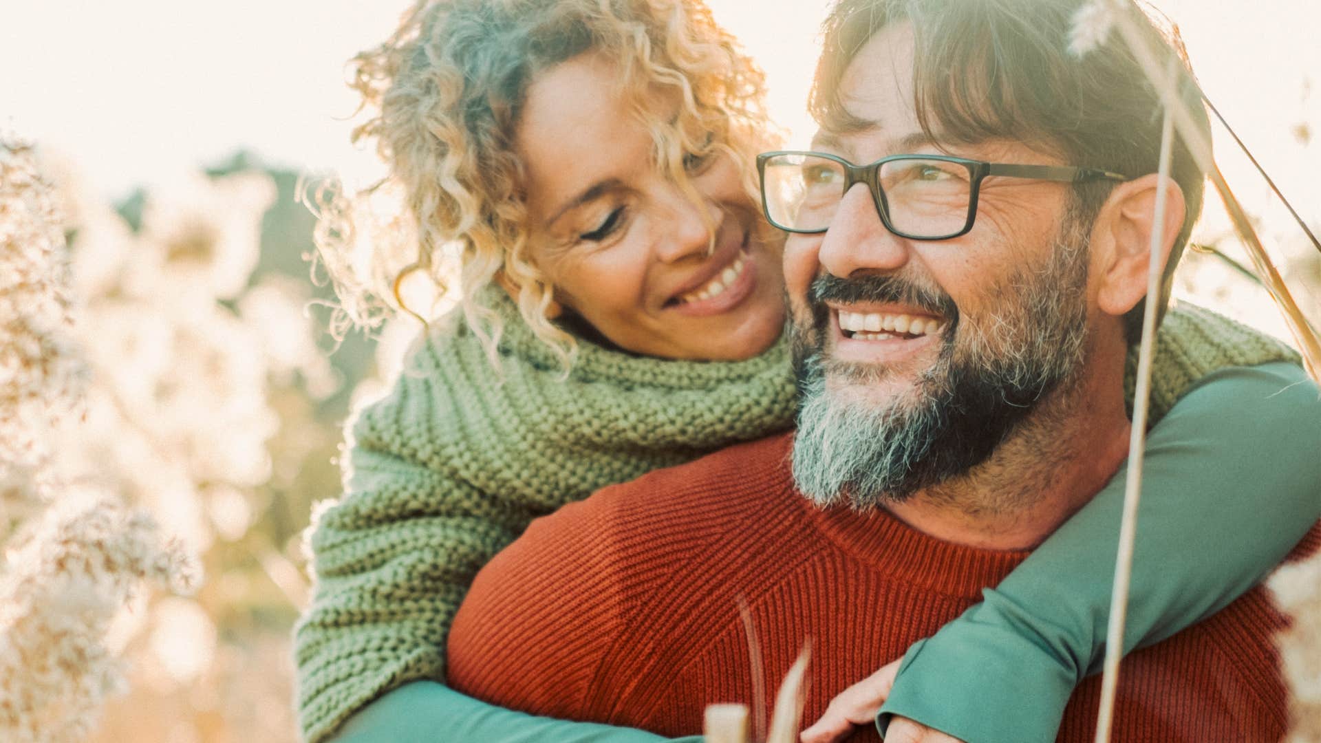 self confident man giving wife a piggyback ride