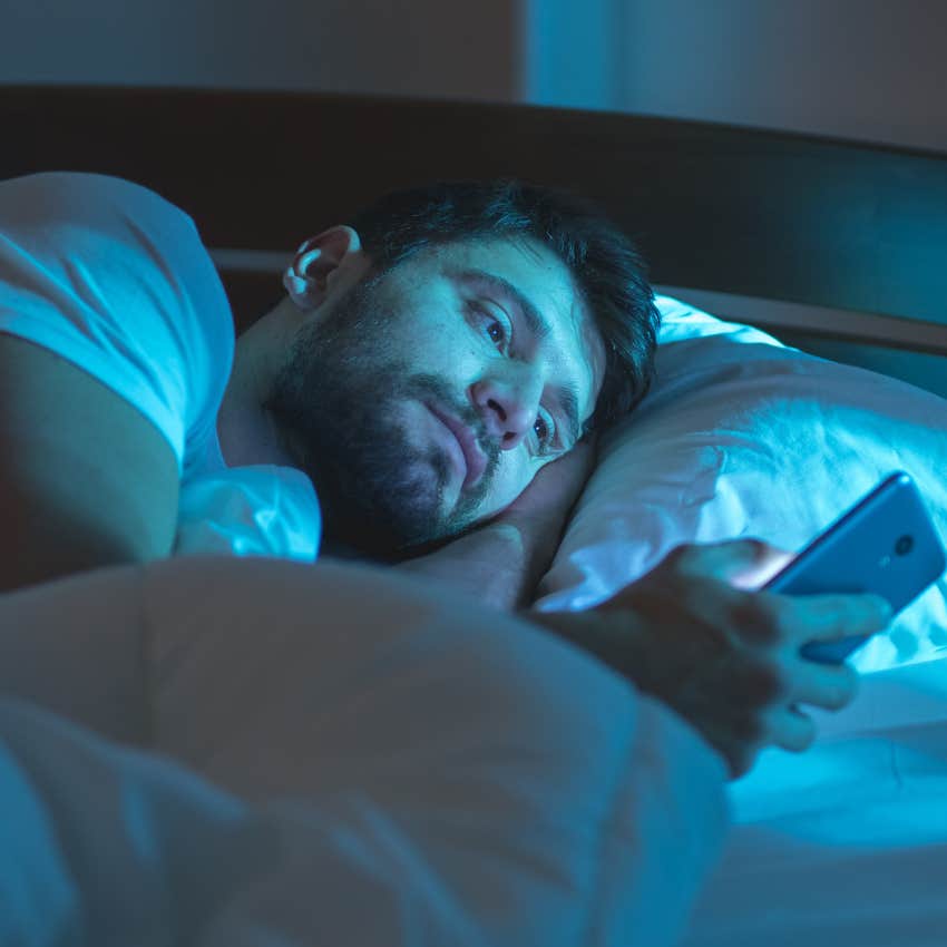 Man thinking about the stress of the next day in his bed.