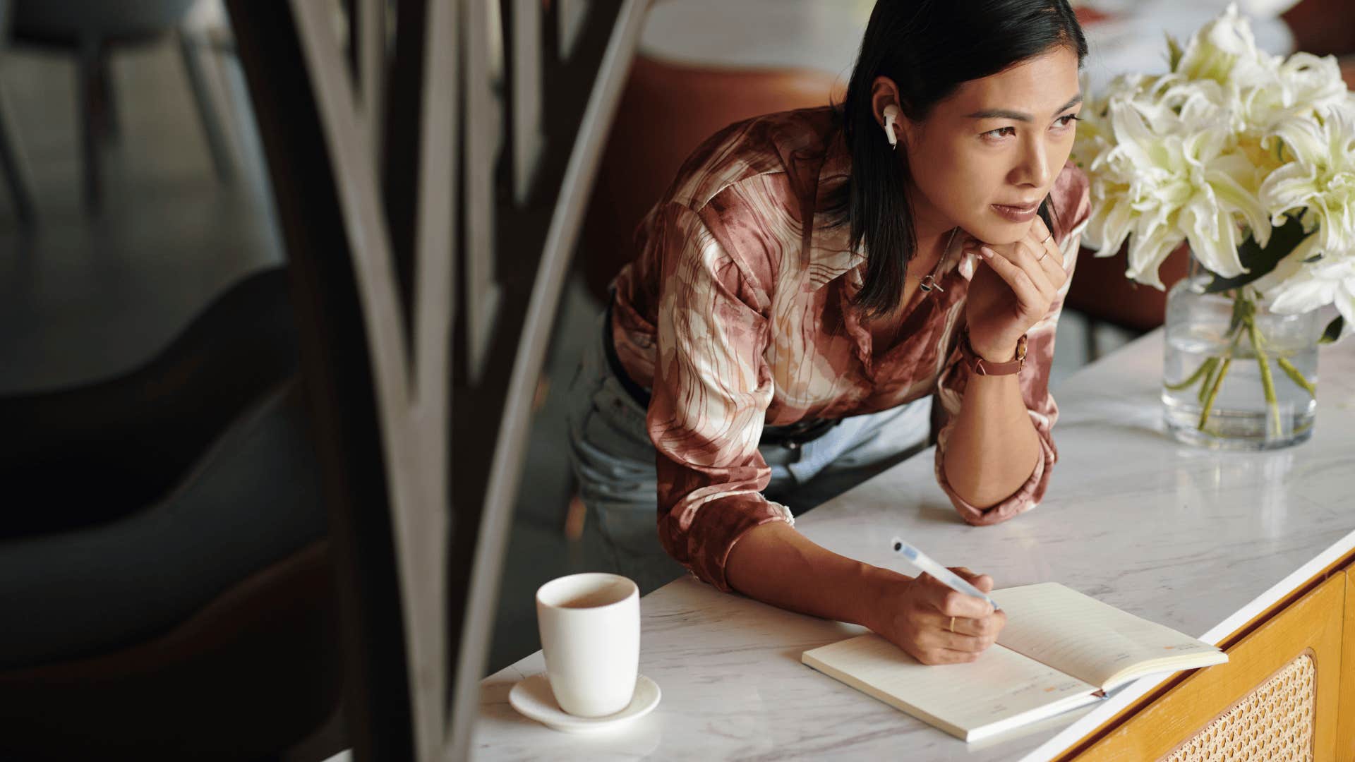 woman writing in a gratitude journal