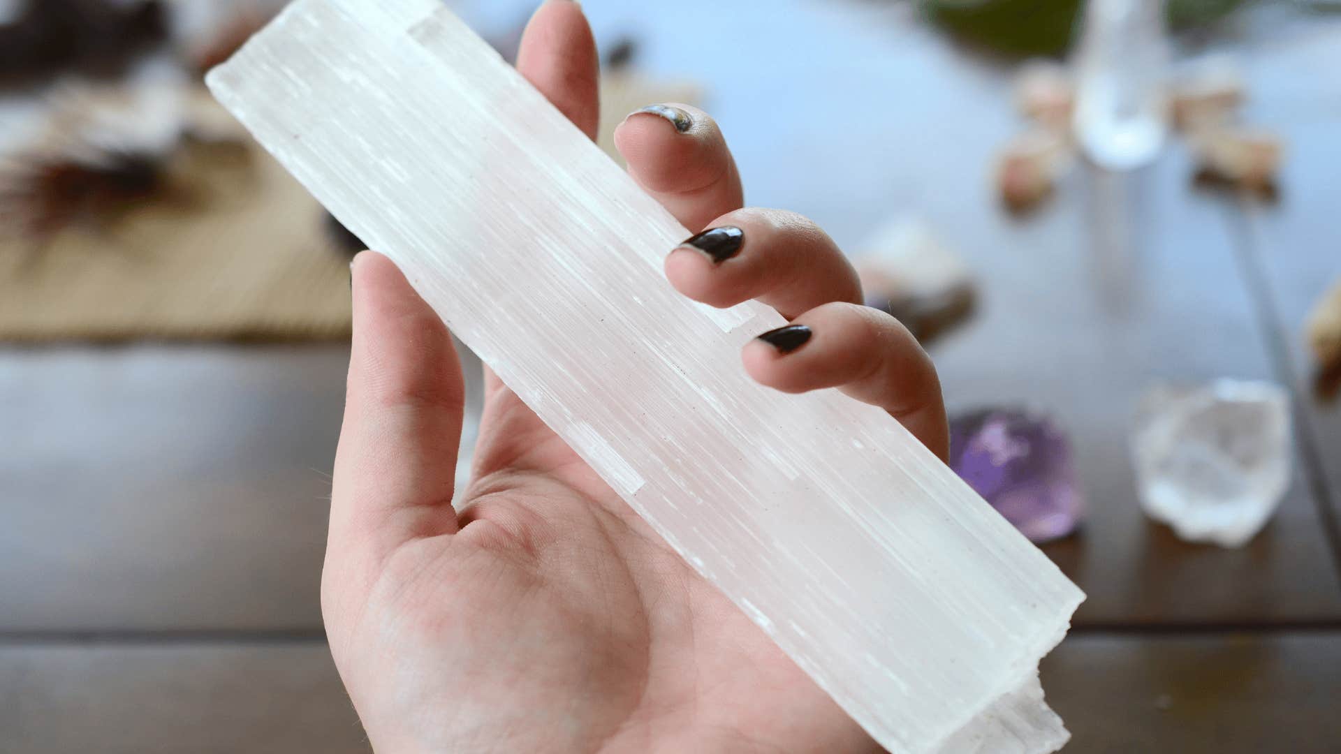 woman doing an energy sweep with selenite