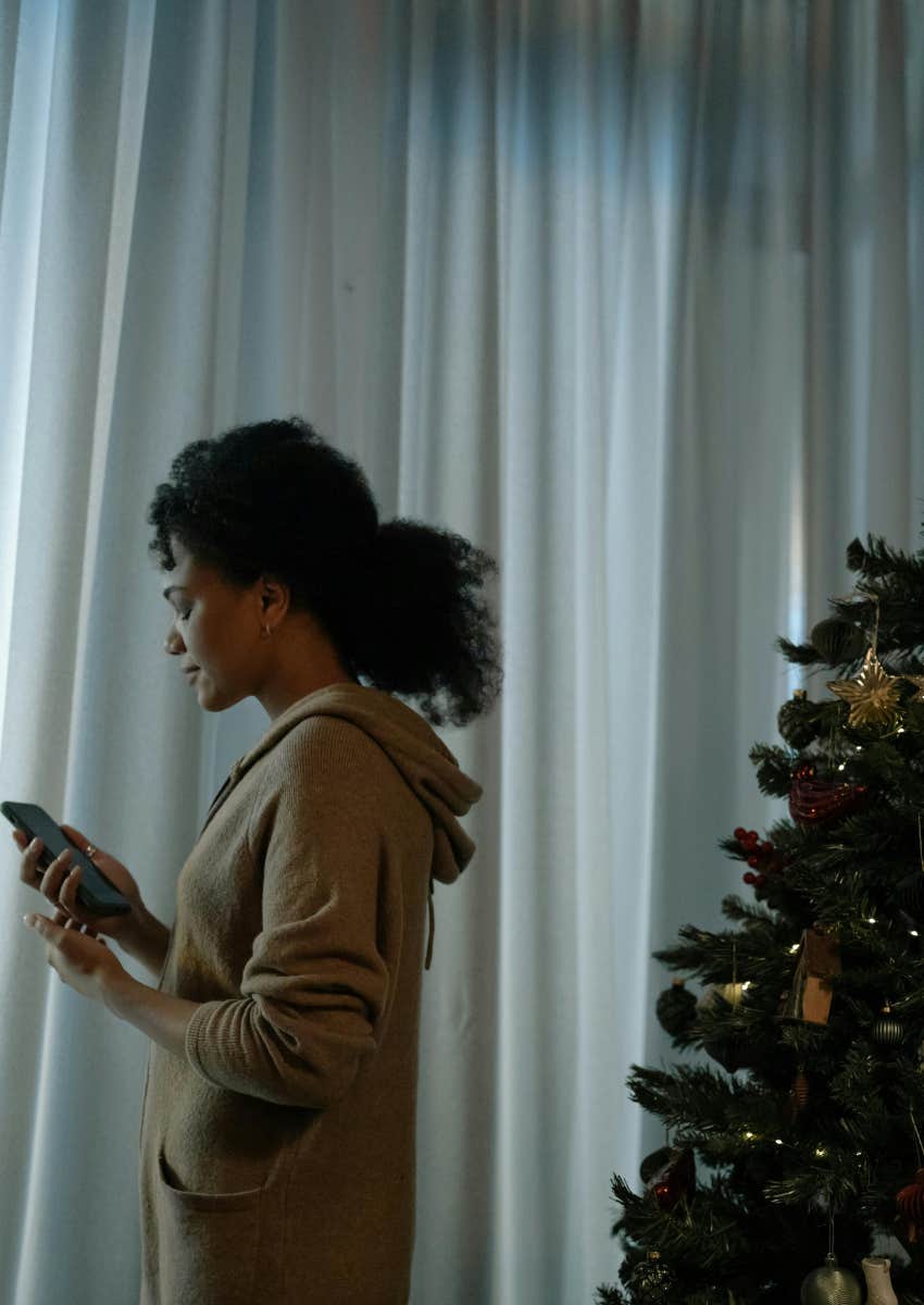 sad mom by the Christmas tree