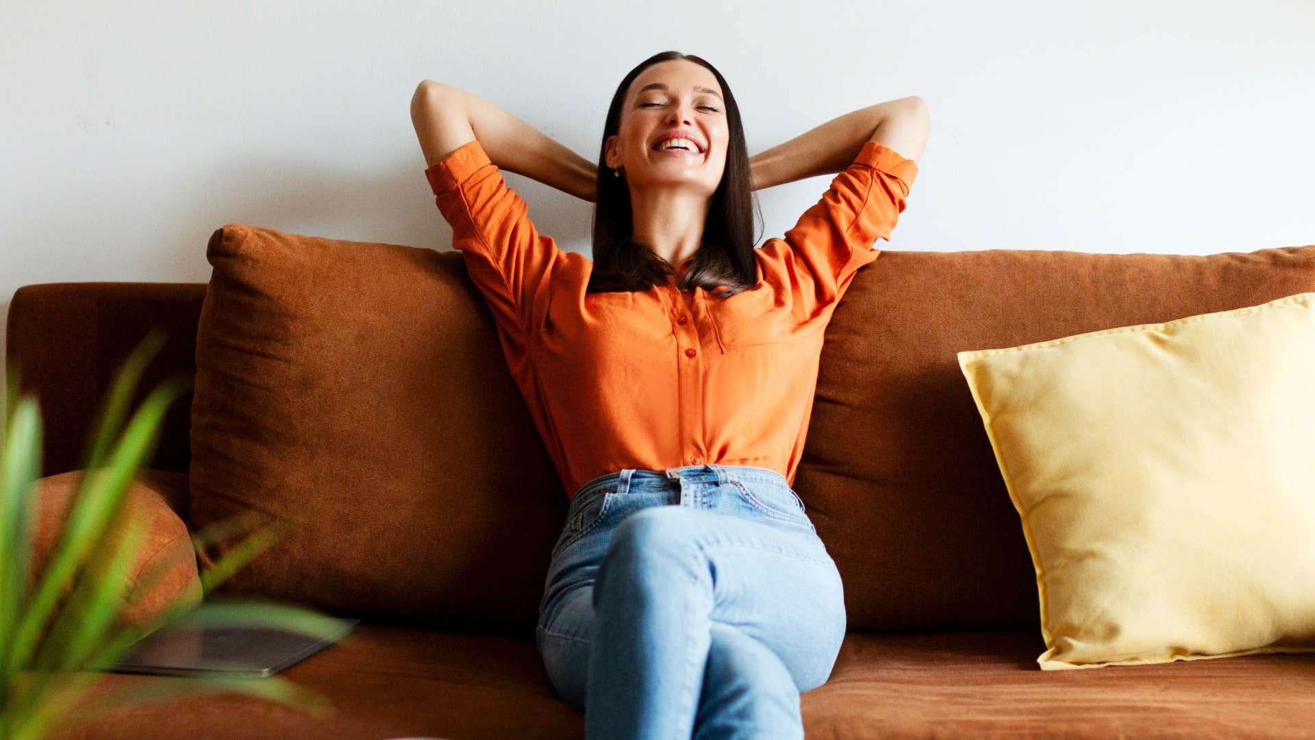 woman with a vivid imagination daydreaming on her couch