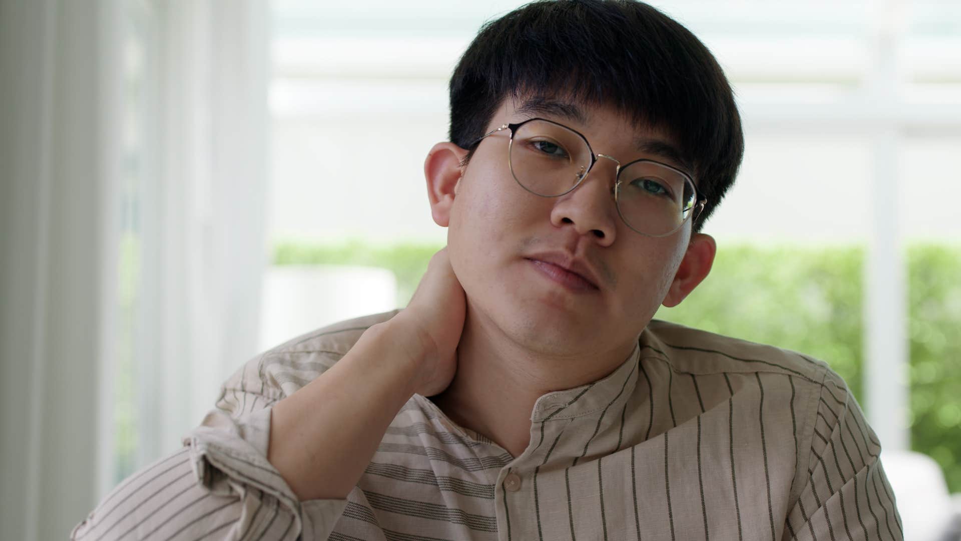 awkward man deflecting compliments and praise