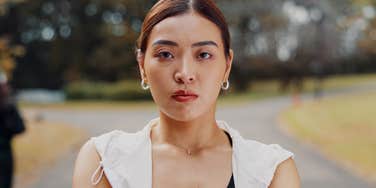 stern woman standing outside to exercise