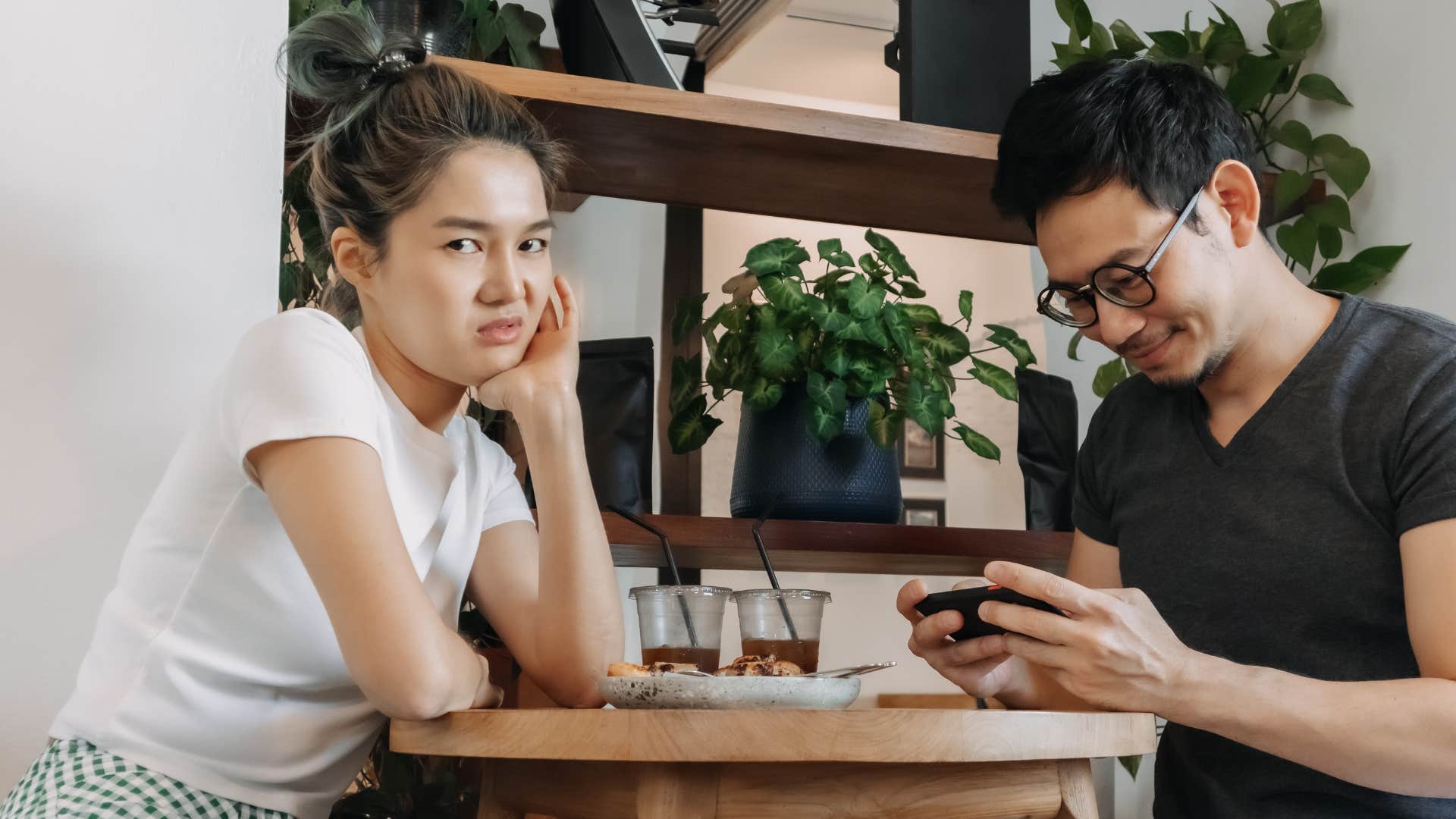 Blunt person annoyed by distracted friend showing they grew up differently 