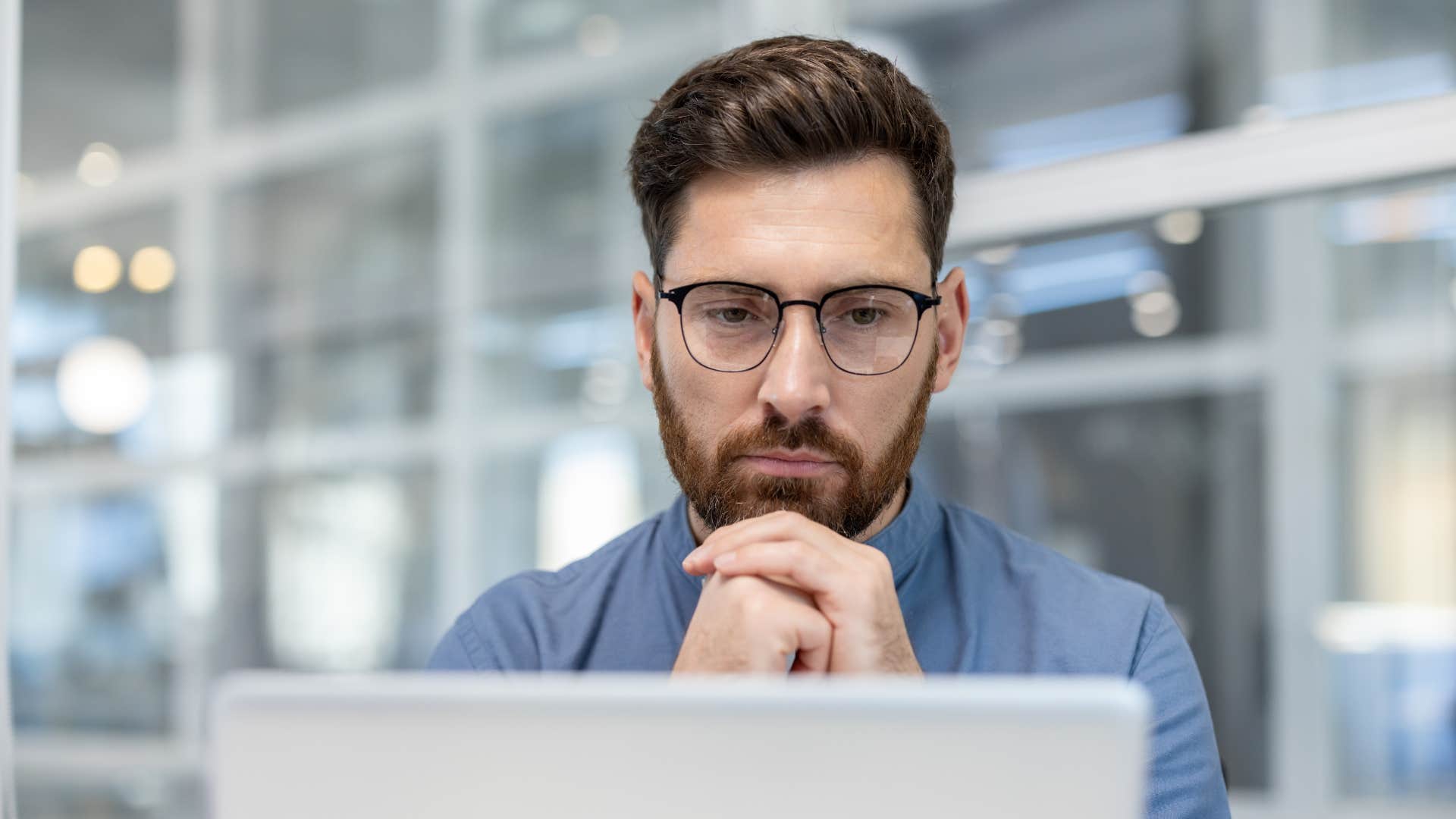 focused man saying i can't be bothered while working