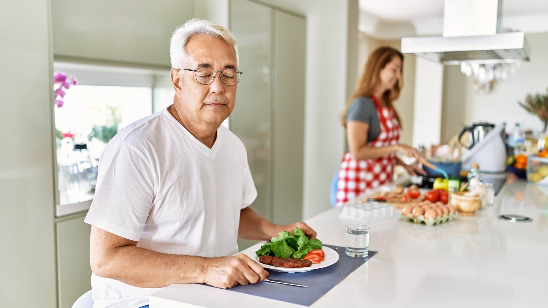 older gentleman struggling to eat around others