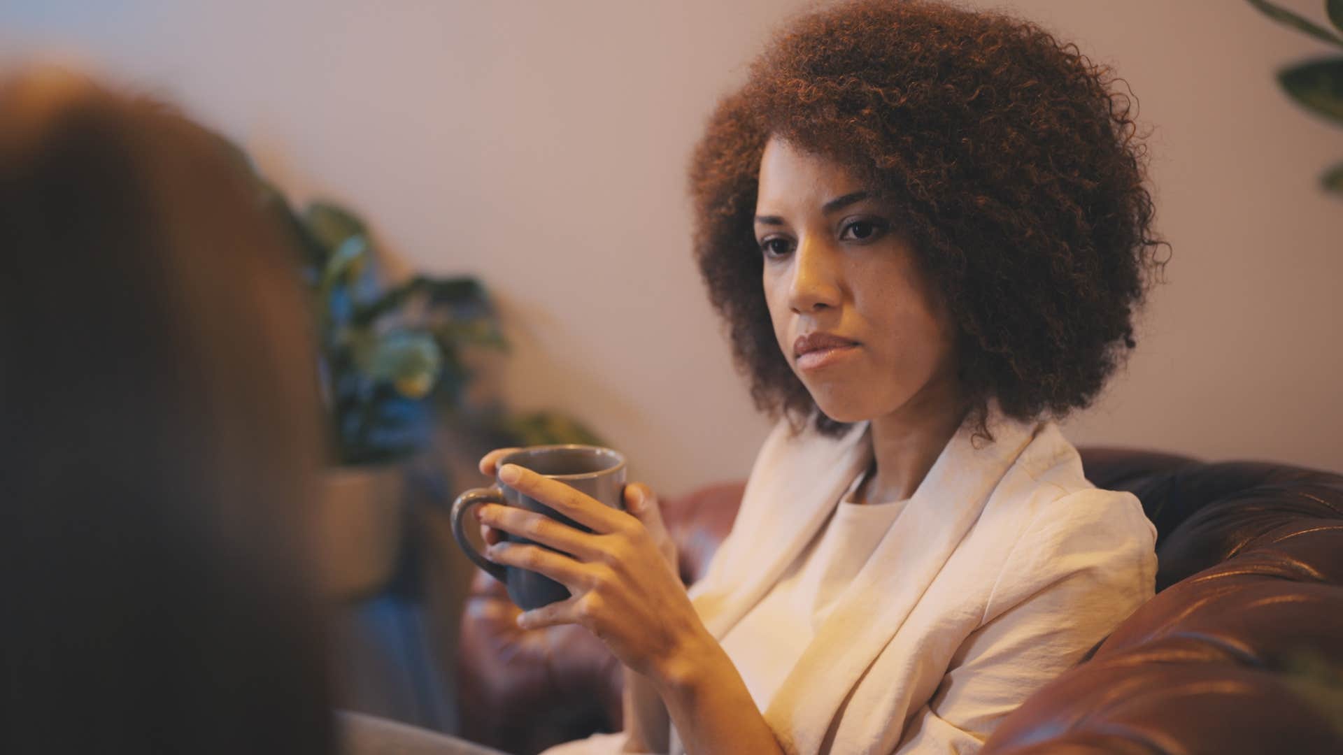 woman feeling pressured to justify her success to a friend