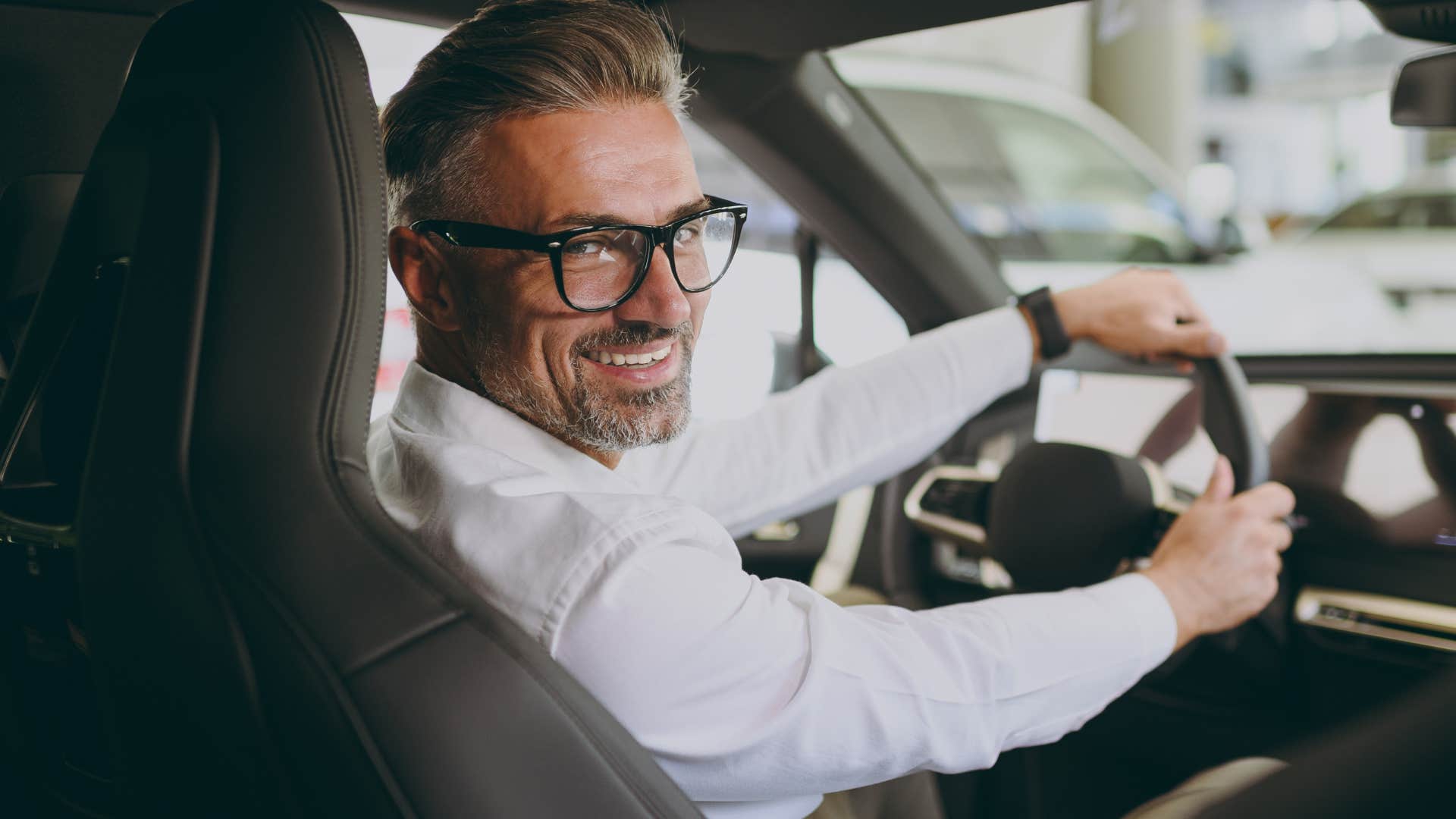 man driving a status symbol car with no real purpose