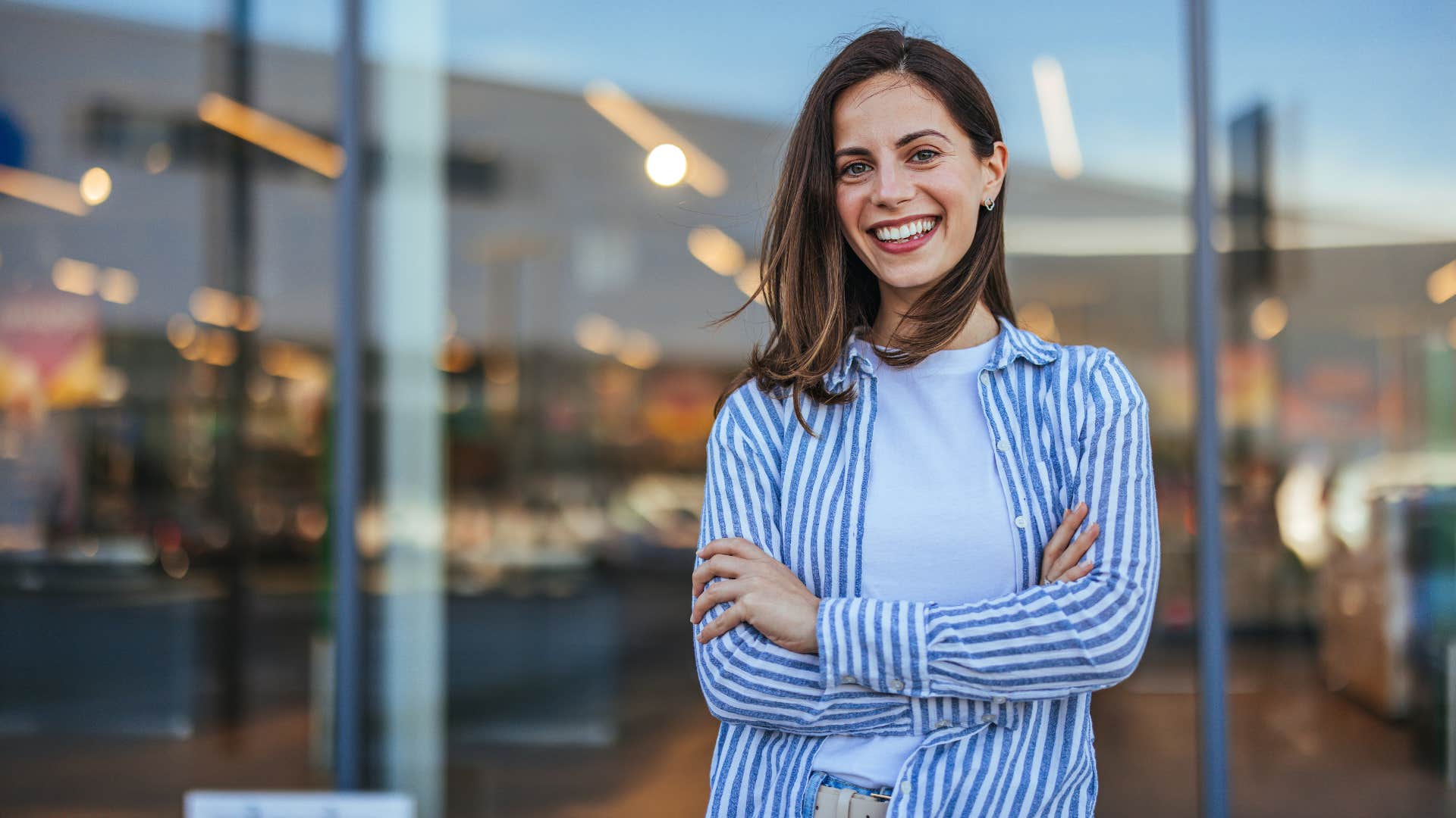 happy woman smiling crossing arms