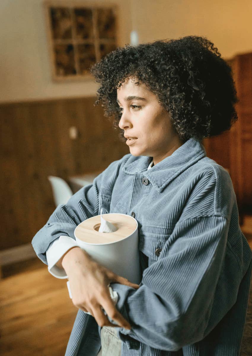 sad woman holding a box of tissues close
