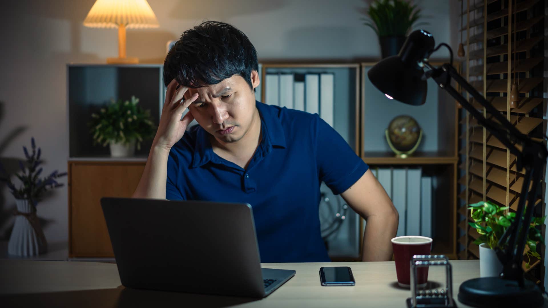 Exhausted person works late showing burnout