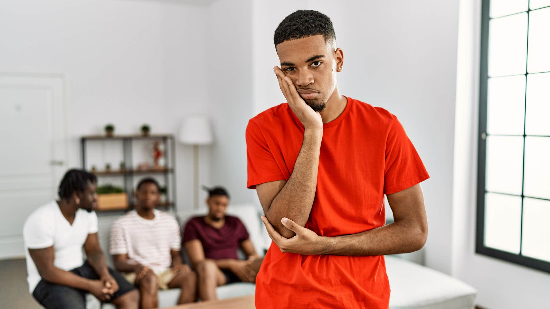 Sad person stands apart from friends showing burnout