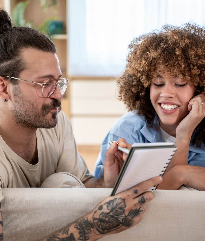 Communicative couple write plan in notebook showing habit to make marriage work
