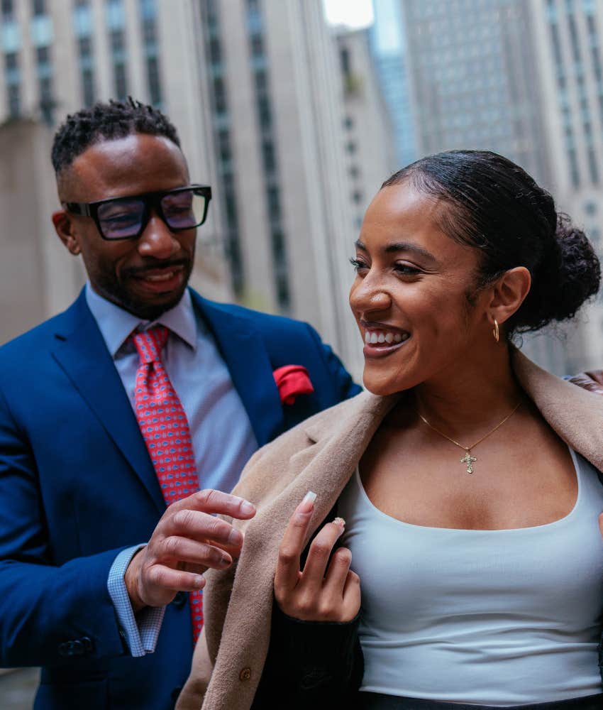 Caring person helps partner with coat showing respect makes marriage work