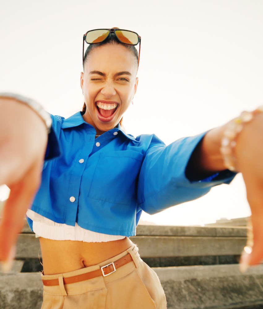 Joyful person has fun outside showing rule to make most of life