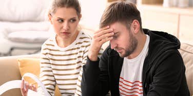 stressed couple arguing about spending habits, capturing the subtle everyday behaviors that reveal early signs of money trouble