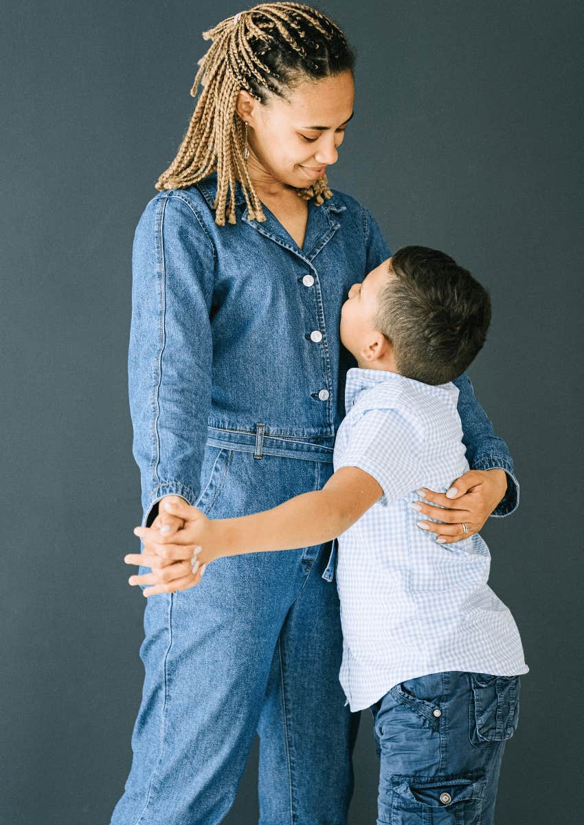 strong mom hugging her young son close