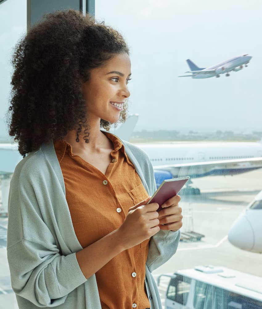 Happy solo traveler with passport ready fly