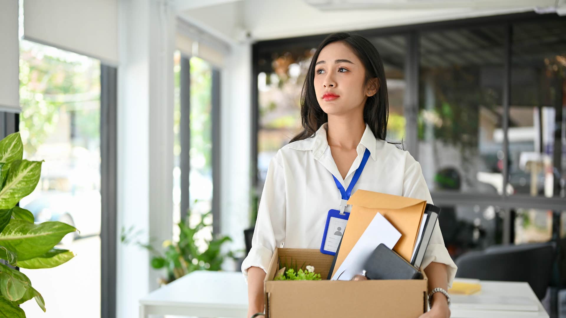 fired employee leaving work with her belongings
