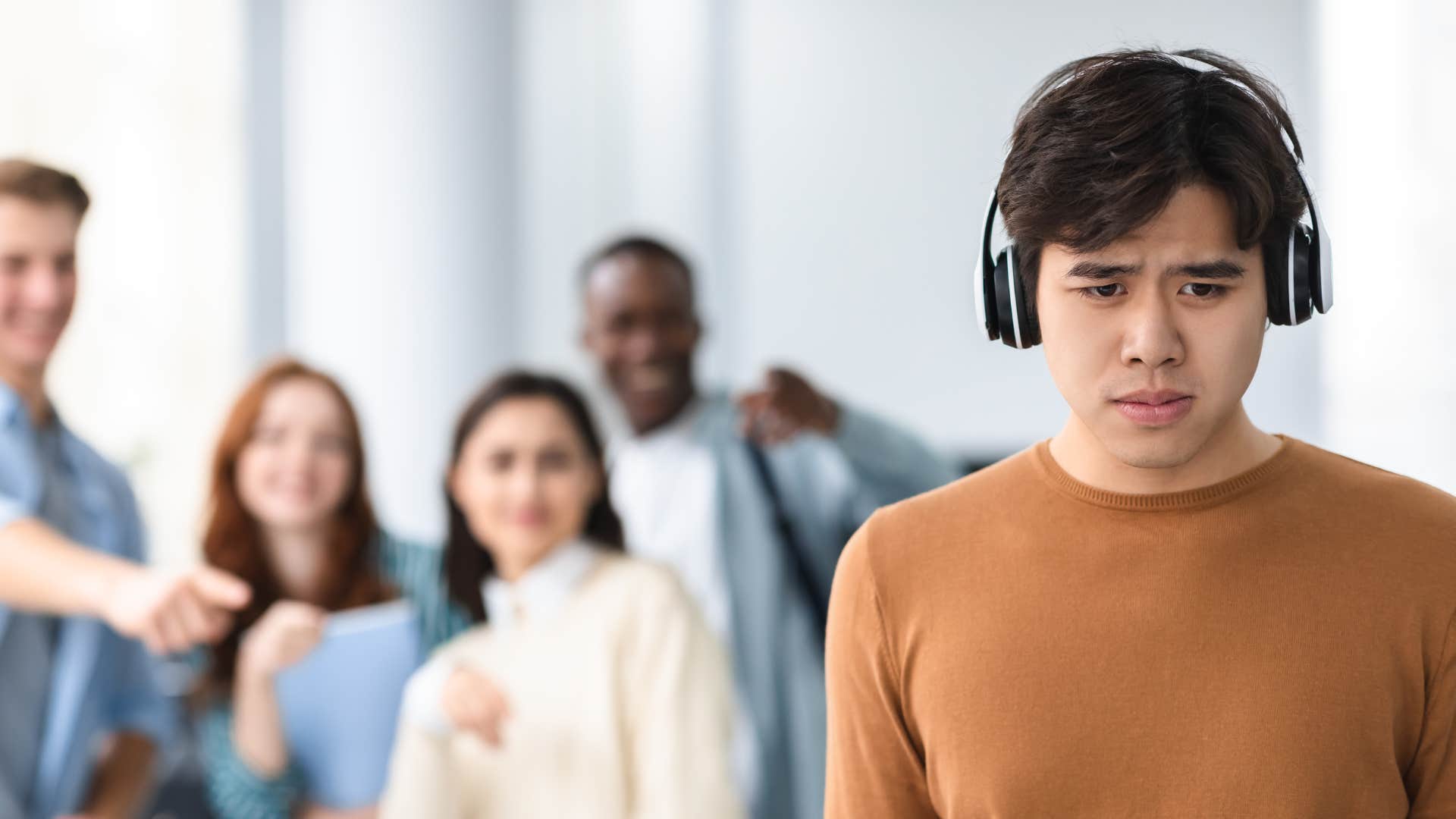 young man being publicly embarrassed by people lacking morals