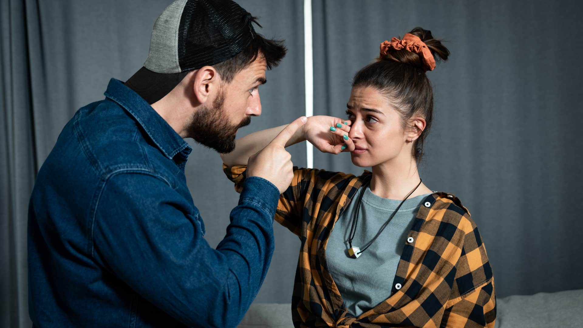 man criticizing woman upsetting her