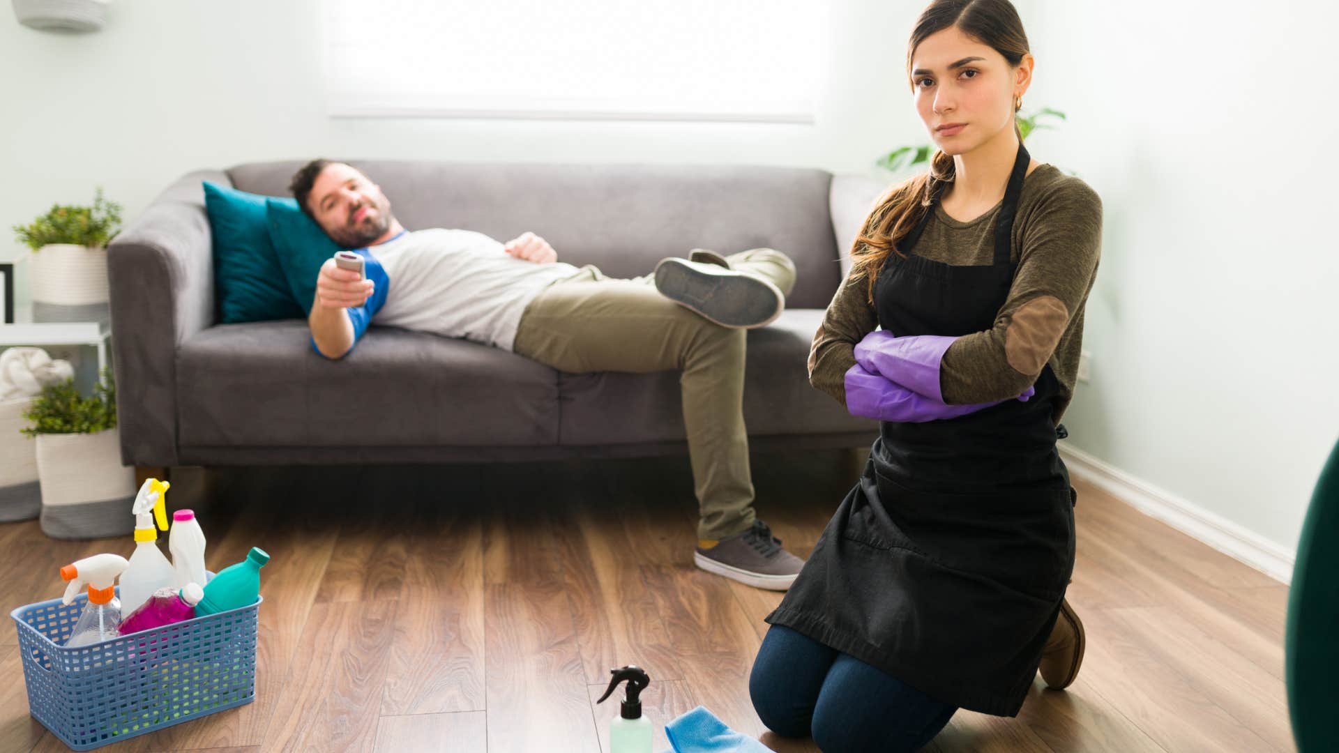 man not picking up after himself while wife cleans