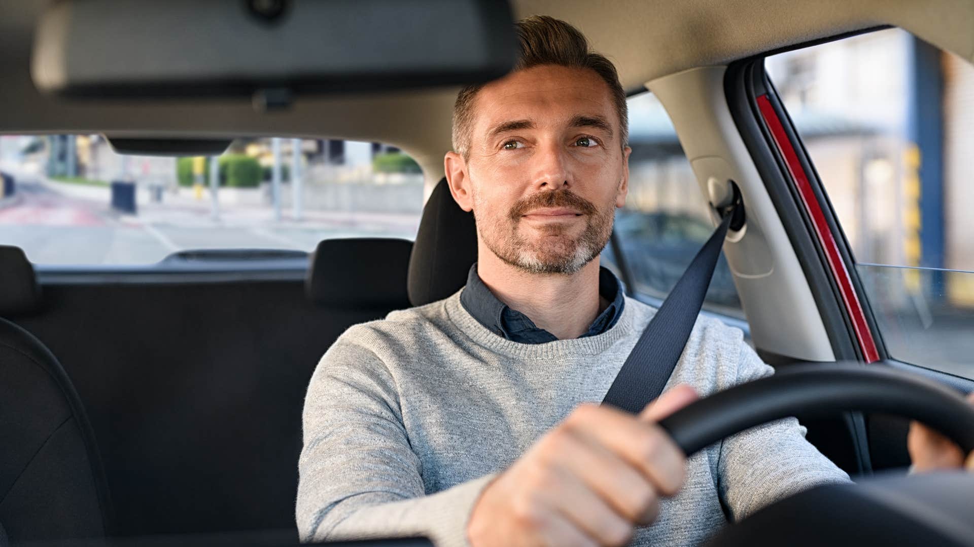man driving his car commuting to work