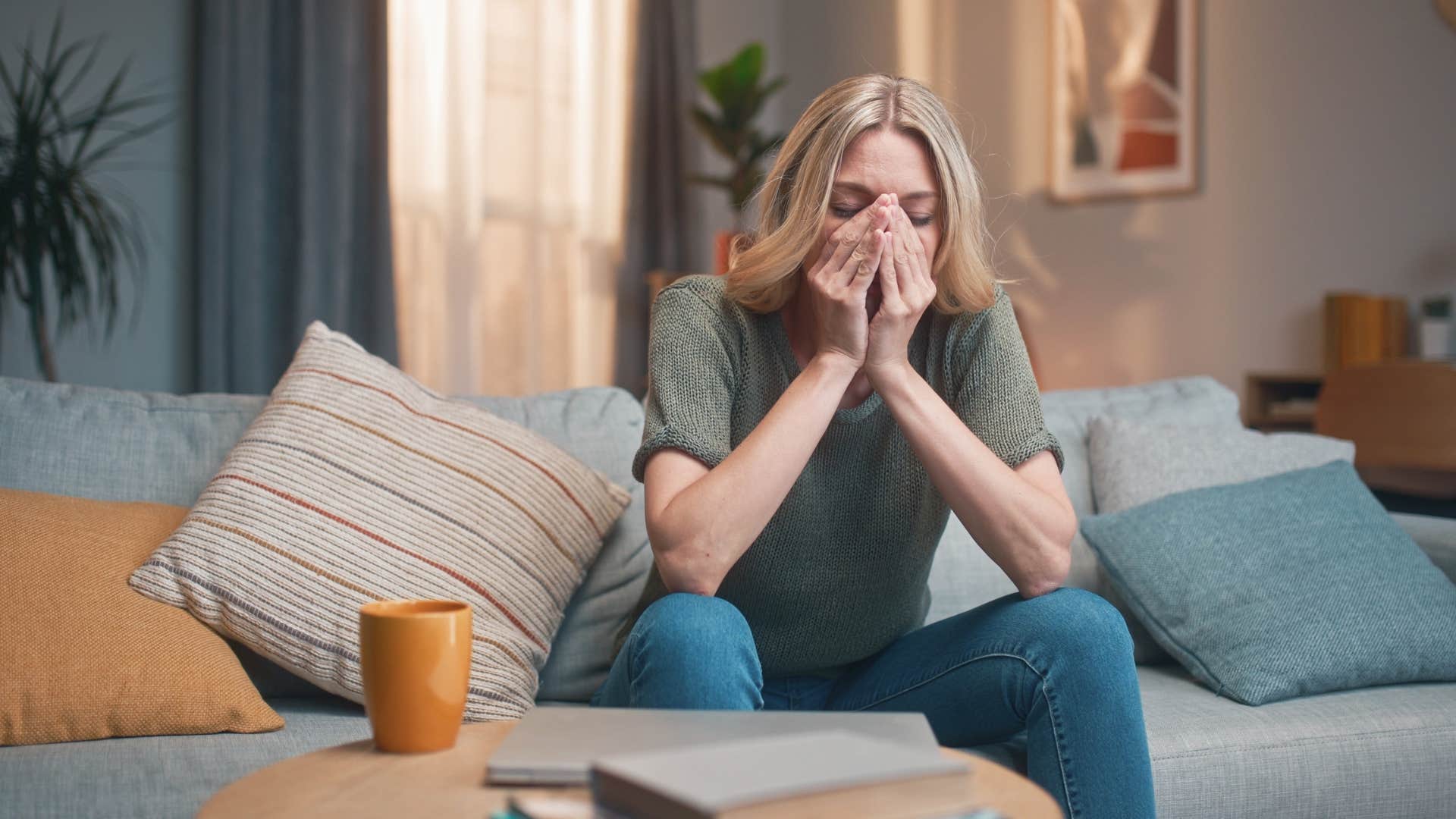 woman at home feeling guilty for taking time off work