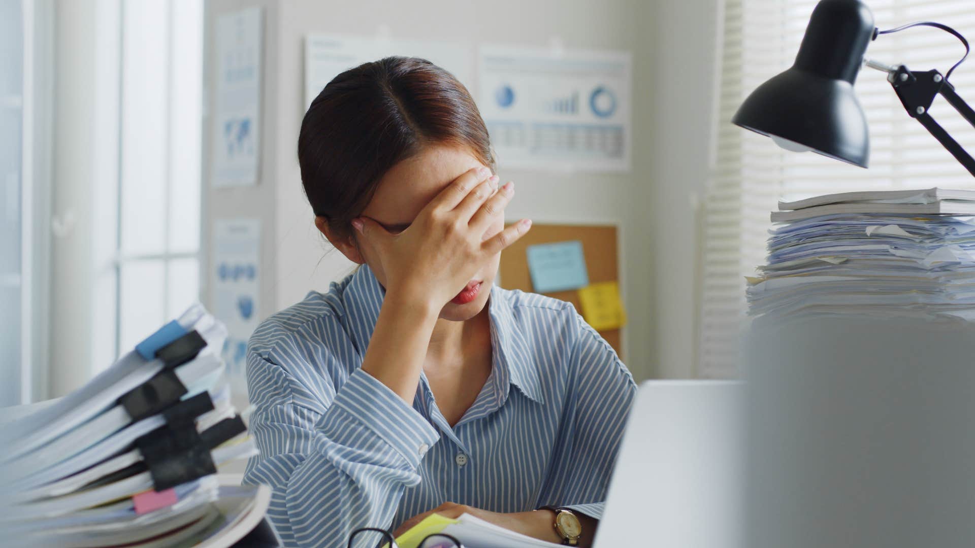 stressed overwhelmed woman struggling to ask for help at work
