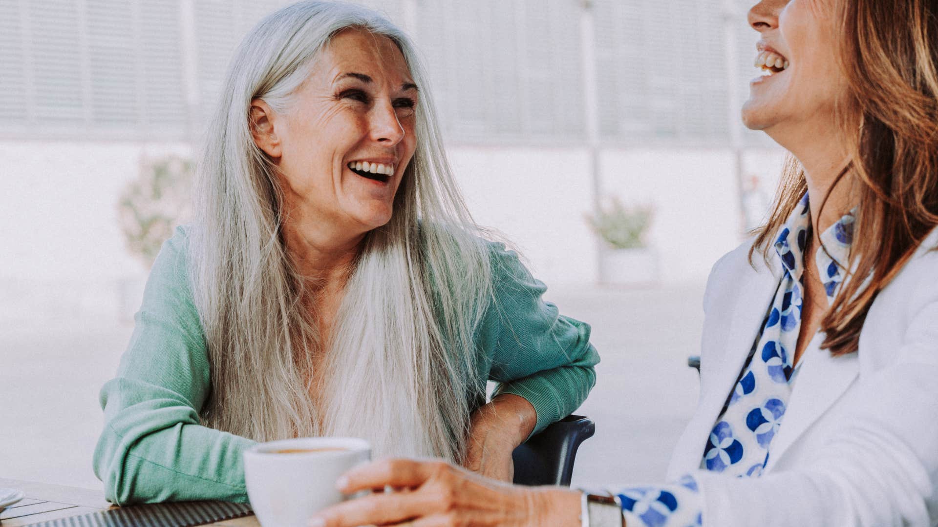 smart woman having debate with a friend in a coffee shop