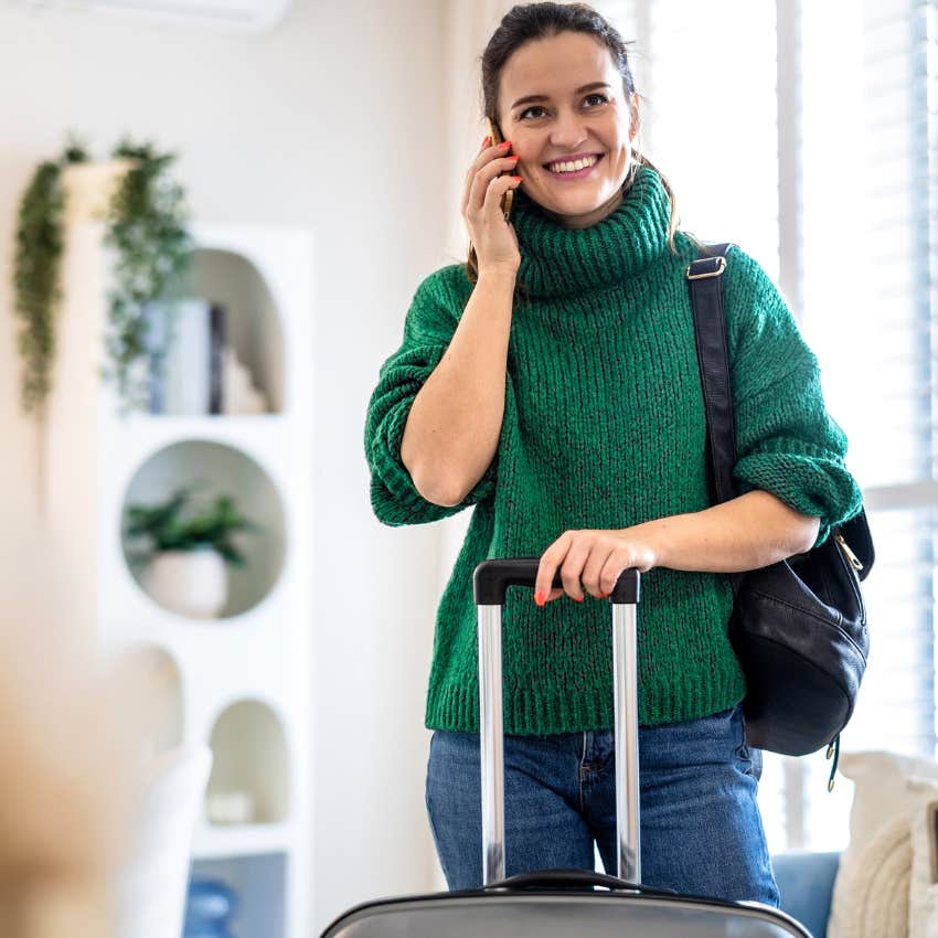 Woman smiling in a guest room at home.