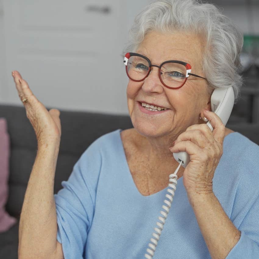 Woman talking on a landline phone at home.